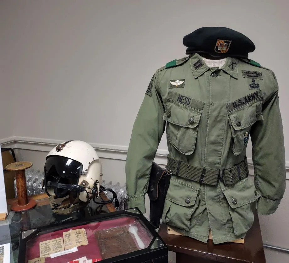 image of an army uniform and flight helmet displayed in a museum