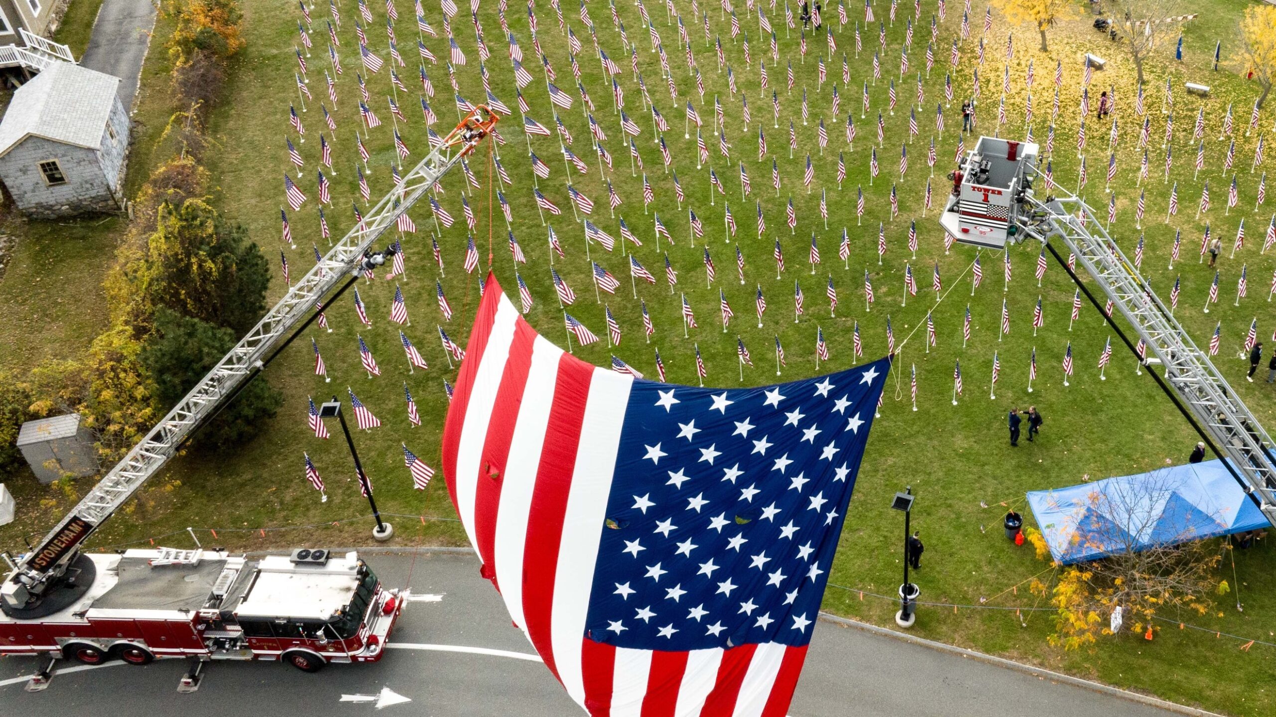 Stoneham Field of Honor photo by Joe Turner, showing a field of American flags with a large flag in the foreground