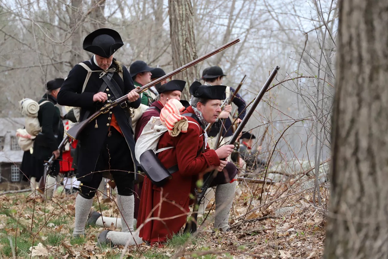 Men in 18th century militia uniforms reenact April 19, 1775